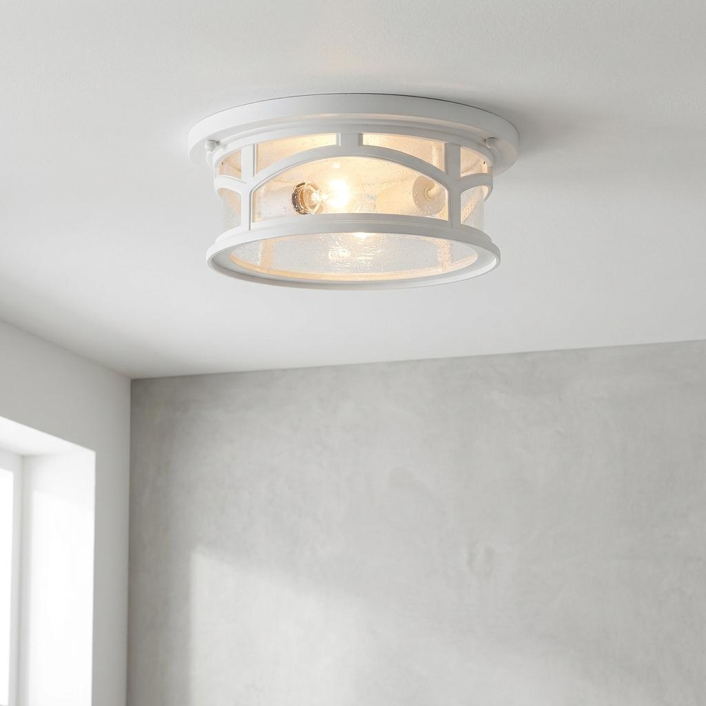 White Quoizel Marblehead flush outdoor ceiling light with seeded glass and lattice detail mounted on a ceiling.