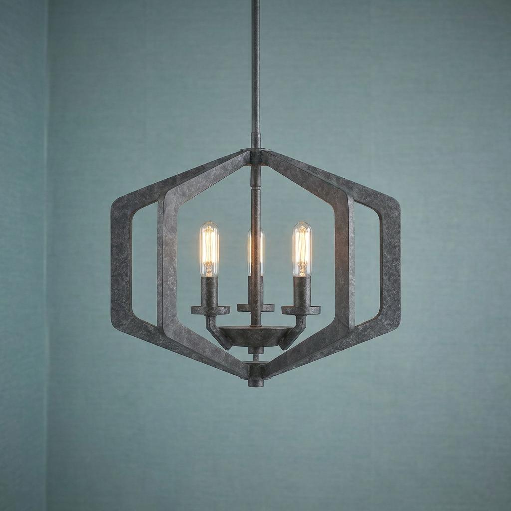Quoizel Vanguard 3-light black pendant with a hexagonal frame and Edison bulbs against a teal wall.