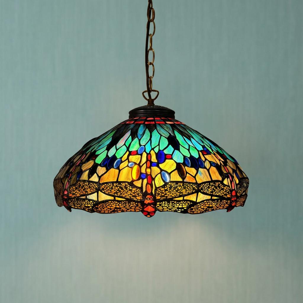 A vibrant Rainbow Dragonfly Tiffany pendant light with multicolored stained glass hanging from a bronze chain.