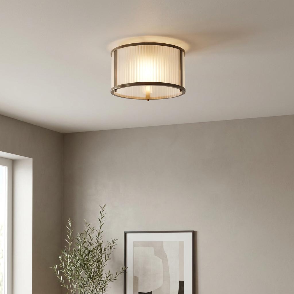 Antique brass flush ceiling light with ribbed frosted glass shade in a modern living space.