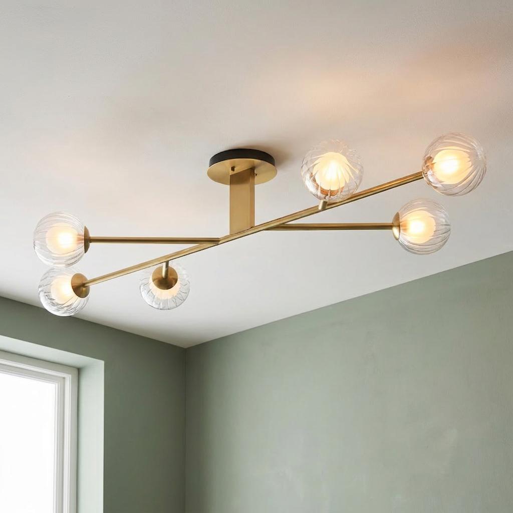 Modern Riviera 6 light semi-flush ceiling fixture with brass arms and clear ribbed glass shades in a green room.
