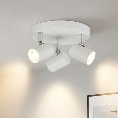 Rollo 3-light white cylinder head flush adjustable spotlight mounted in a modern grey living room.