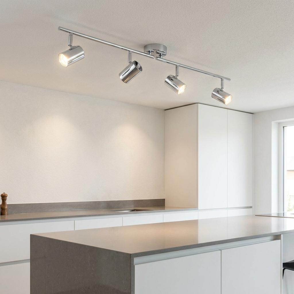 Rollo 4 light chrome adjustable split bar ceiling spotlights illuminating a modern white kitchen island.
