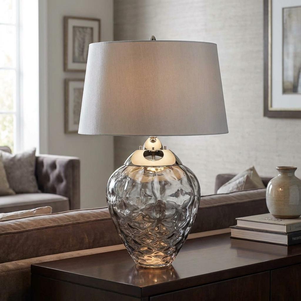 Samara smoked glass table lamp with a rippled base and grey drum shade on a wooden console table.