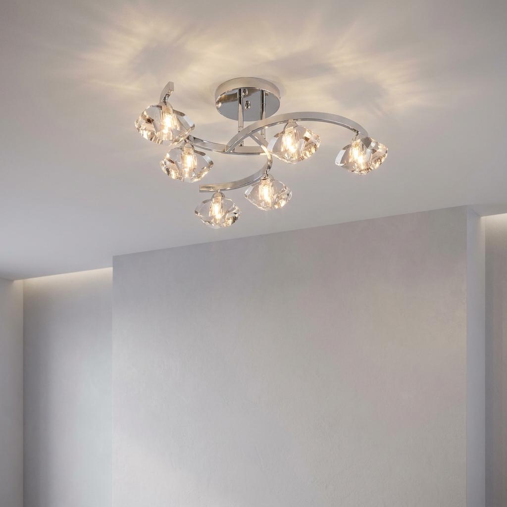 Sculptured 6-light semi-flush ceiling light with chrome curved arms and faceted glass shades in a white room.