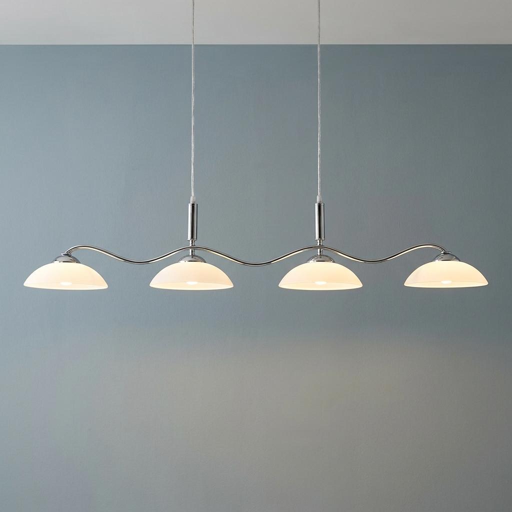 Searchlight Alexis 4-light chrome bar pendant with white opal glass shades glowing against a blue wall.