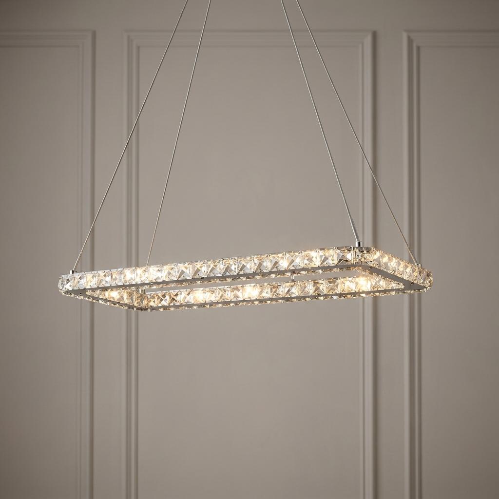 Searchlight Clover LED rectangular chrome and glass pendant light hanging against a neutral paneled wall.