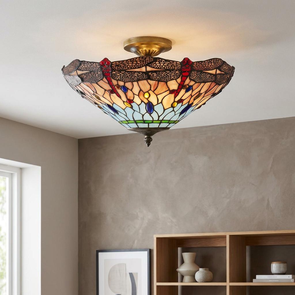 Tiffany-style dragonfly semi-flush ceiling light with colorful stained glass mounted on a neutral room ceiling.