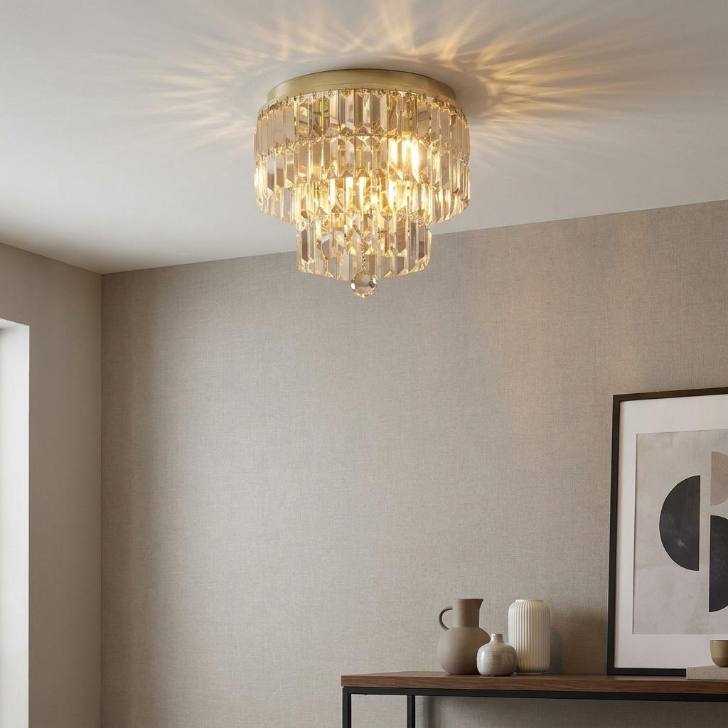 Tiered brass and champagne crystal flush mount light casting starburst shadows on a neutral-toned ceiling.