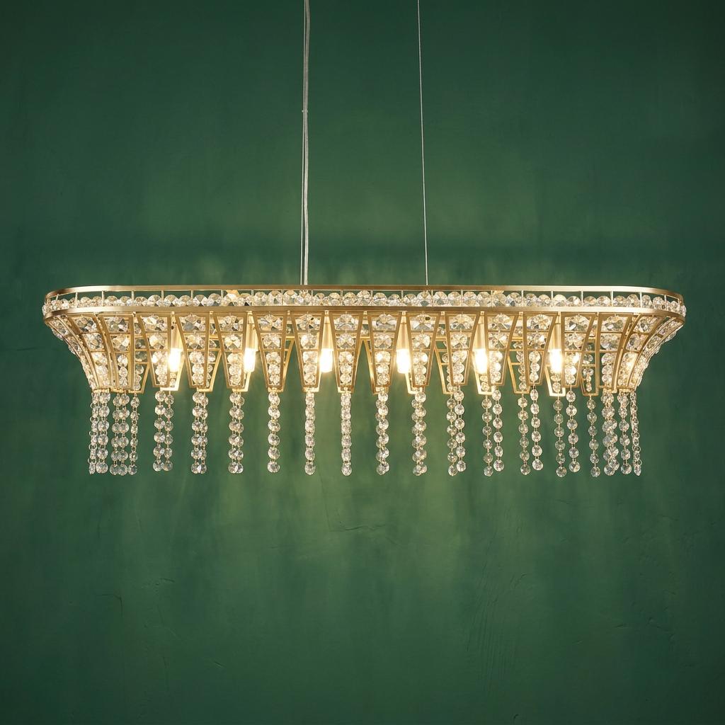Rectangular brass pendant light with eight bulbs and hanging crystal droplets against a textured green wall.