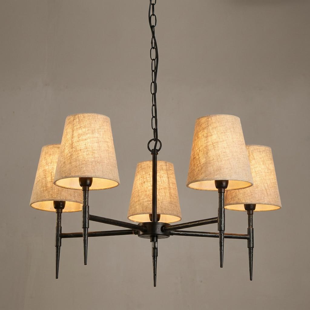 Hammered black 5-light Gothic chandelier with natural linen shades against a plain wall.