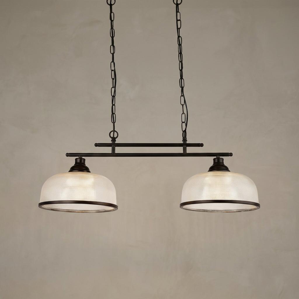 A linear two-light pendant with black metal frame and ribbed holophane glass shades hanging from chains.