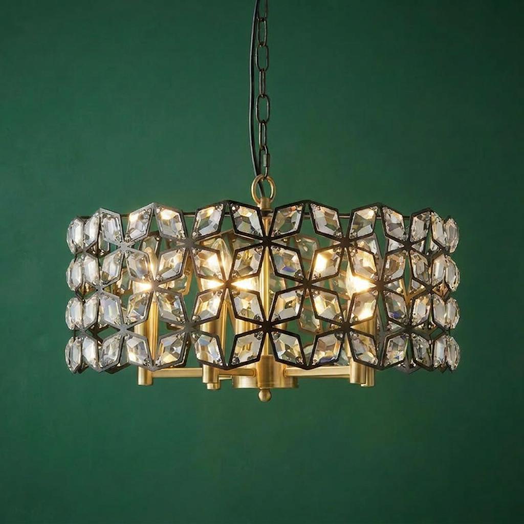 Searchlight Iris 5-light pendant with black geometric crystal frame and brass accents against a dark green wall.