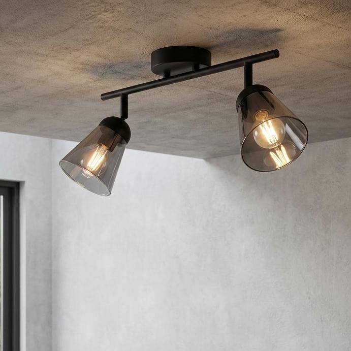 Modern two-light black ceiling spotlight with smoked glass shades illuminating a wooden kitchen island.