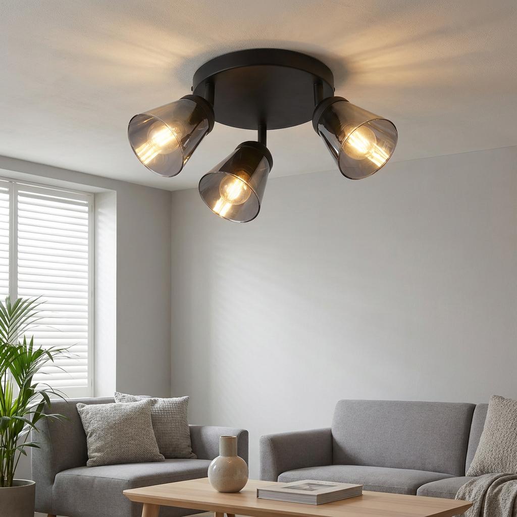Modern three-light black ceiling spotlight with smoked glass shades illuminating a contemporary living room.