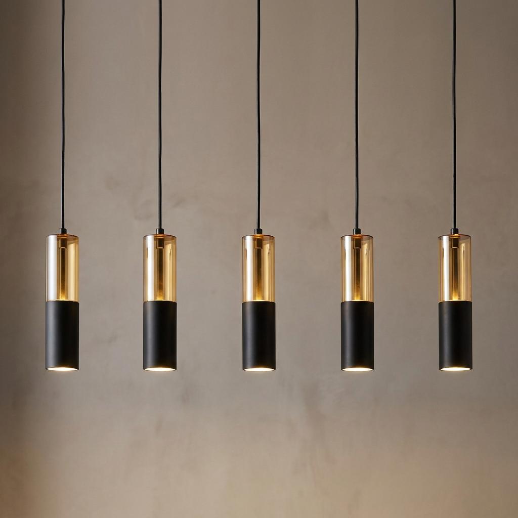 Row of five cylindrical black and amber glass pendant lights illuminated against a neutral background.