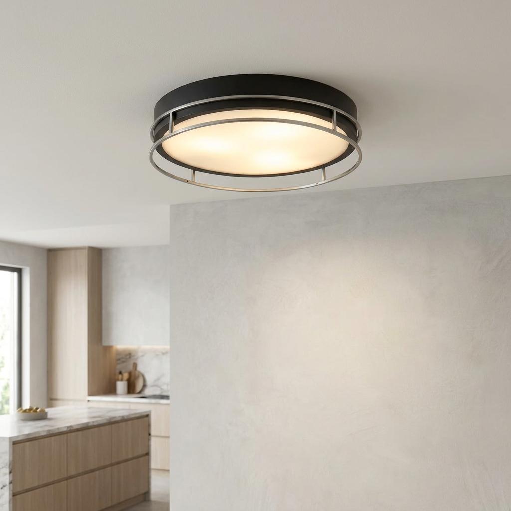 Modern Searchlight Phoenix flush ceiling light with black rim and chrome cage, illuminated in a kitchen setting.