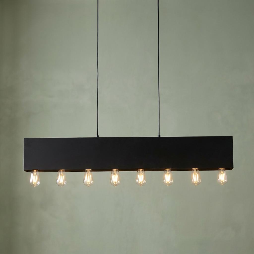 Searchlight Piano 8-light black diner bar pendant with exposed glowing bulbs against a pale green wall.