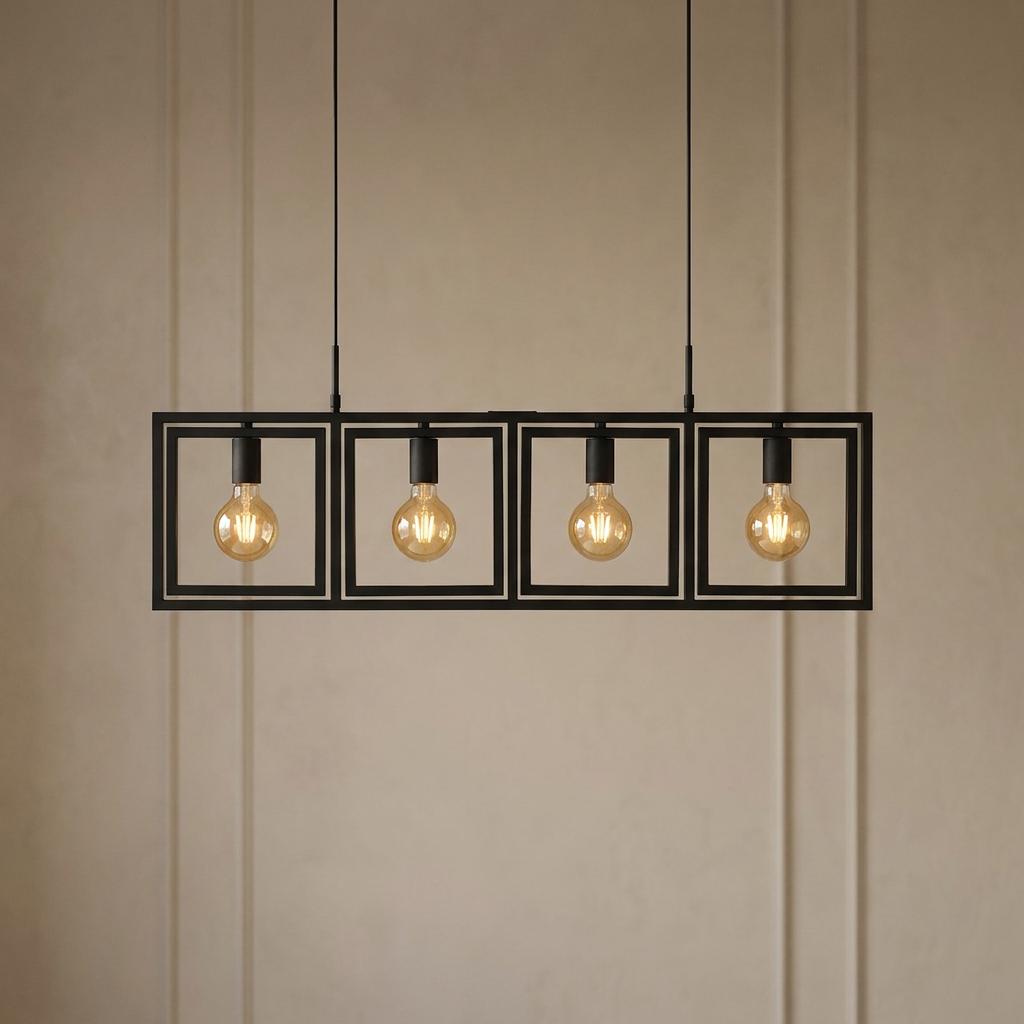 Modern black four-light linear pendant with square frames and glowing filament bulbs against a textured wall.