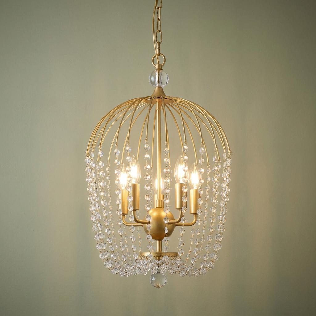 Gold cage pendant light with cascading crystal beads and five glowing candle-style bulbs.