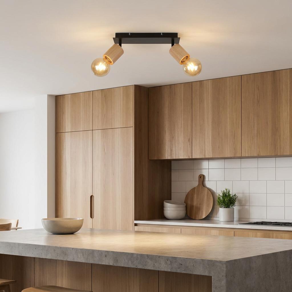Modern two-light ceiling spotlight with black base and wood cylinders over a wooden kitchen island.