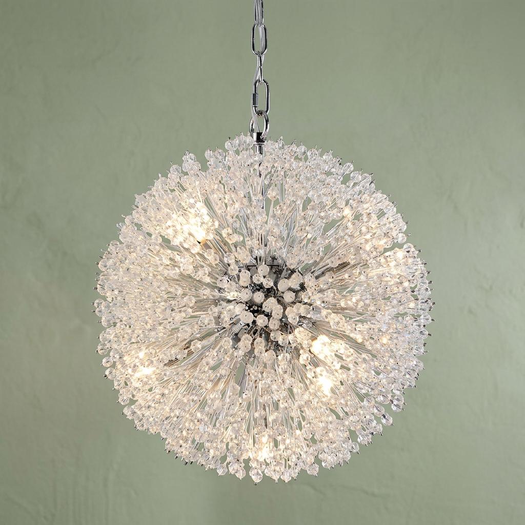 Spherical sunburst pendant light with glass beads and chrome finish illuminated against a green wall.