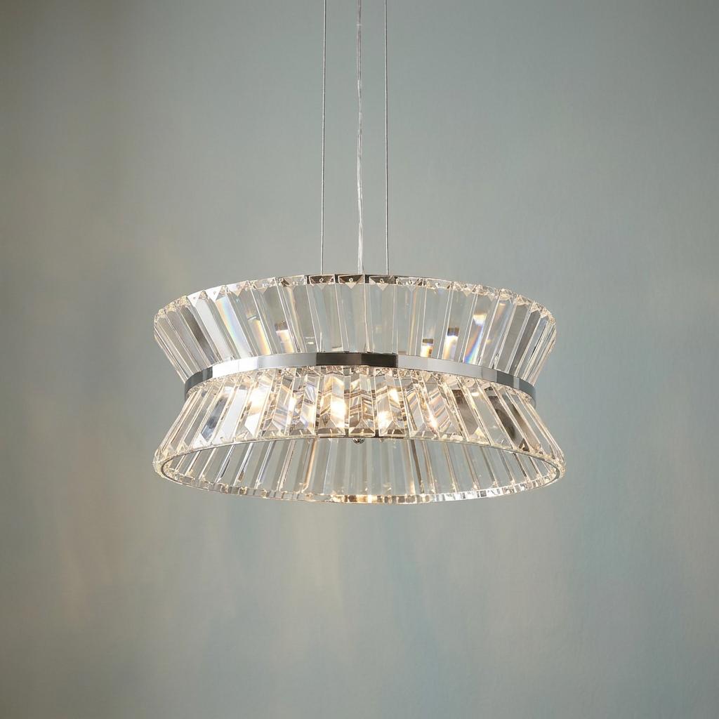 Modern circular chrome and crystal prism pendant light fixture illuminated against a plain background.