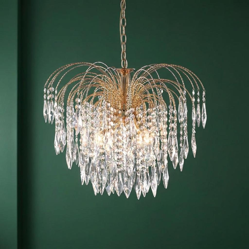 Searchlight Waterfall 5 light gold and crystal pendant with fountain-like cascading drops against a dark green wall.