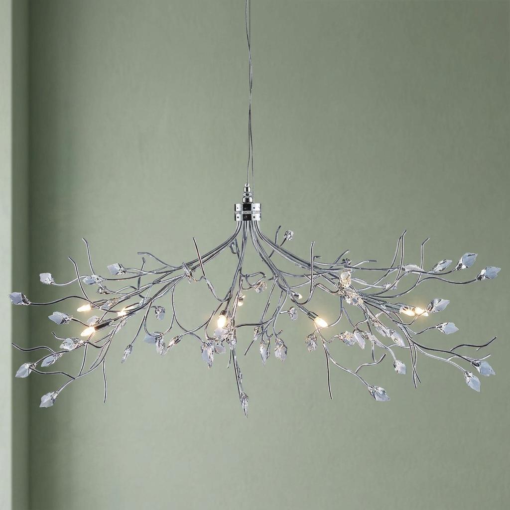 Silver branch-style 8-light ceiling pendant with crystal leaves against a light green wall.