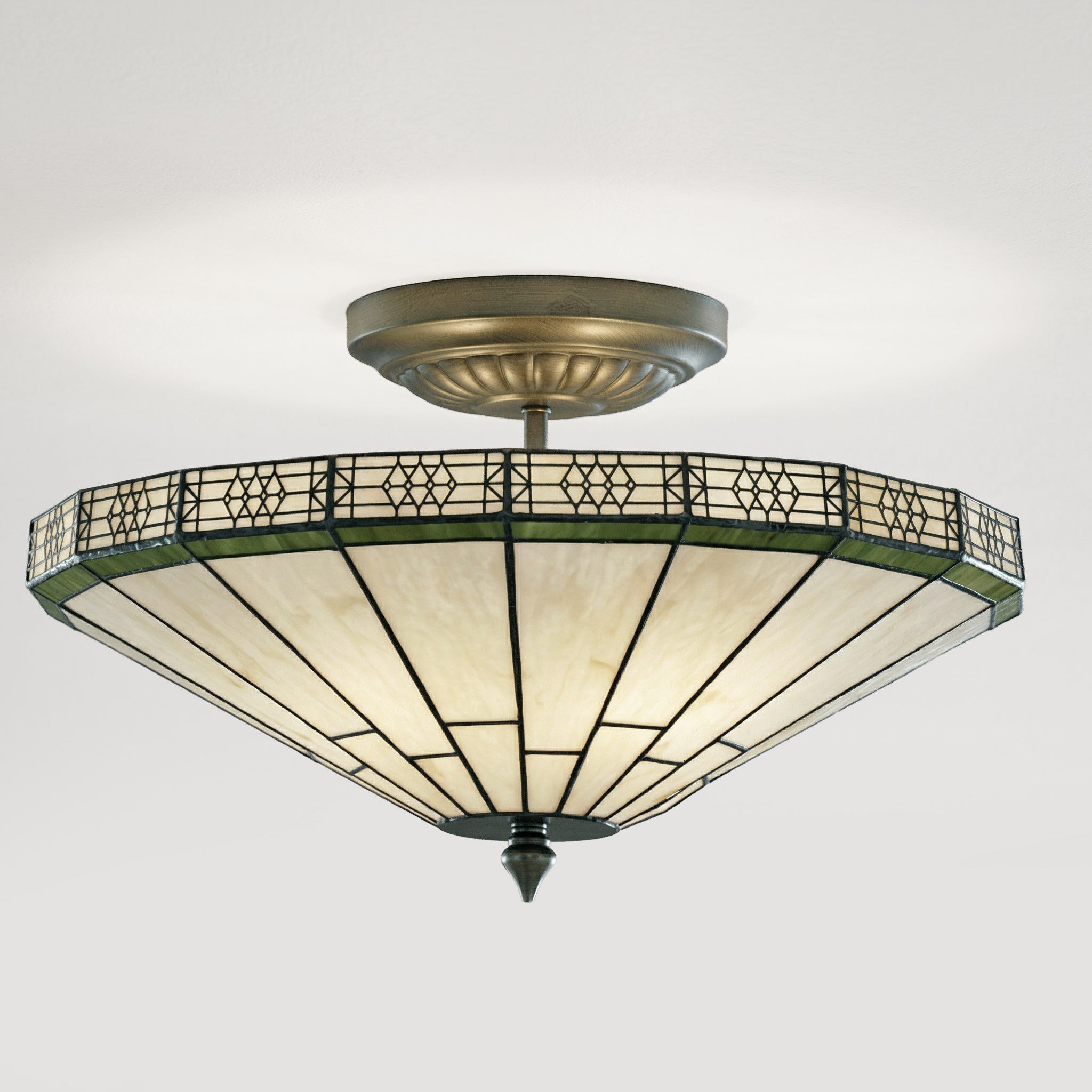 Decorative ceiling light fixture with stained glass shade on a white background