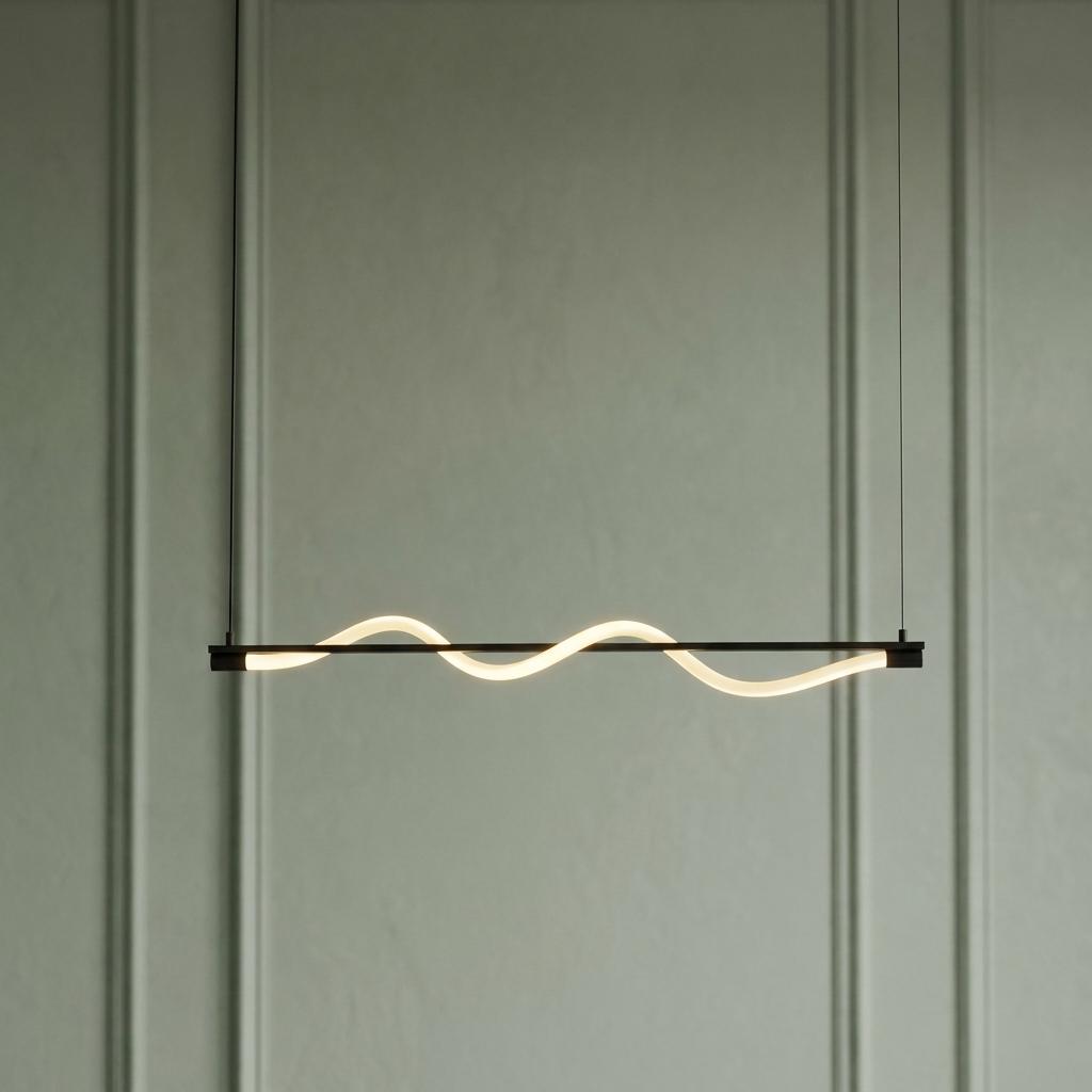 Serpent LED pendant light with a wavy acrylic tube on a horizontal black bar, set against a green paneled wall.