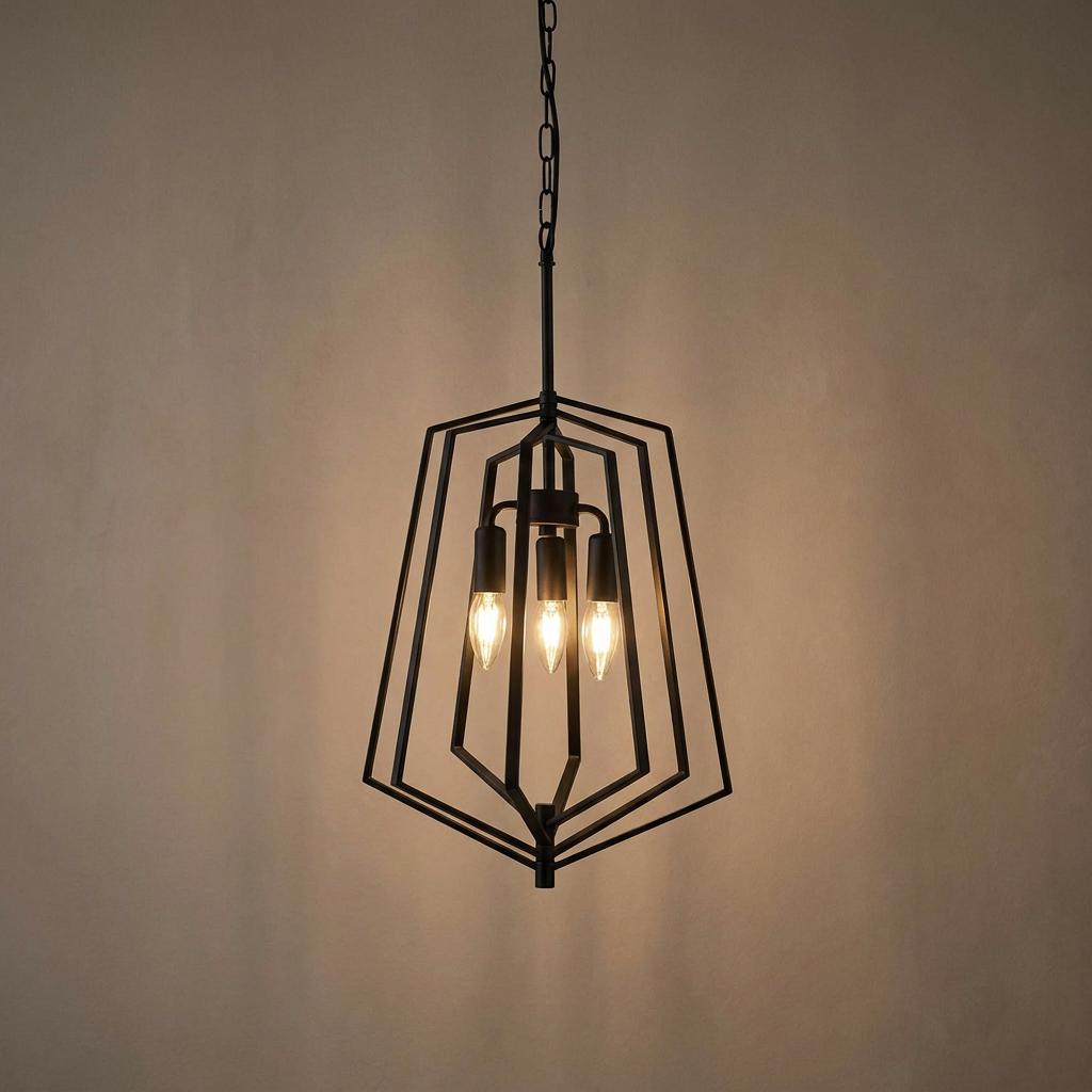 Black metal geometric pendant light with three candle bulbs against a warm, neutral wall.