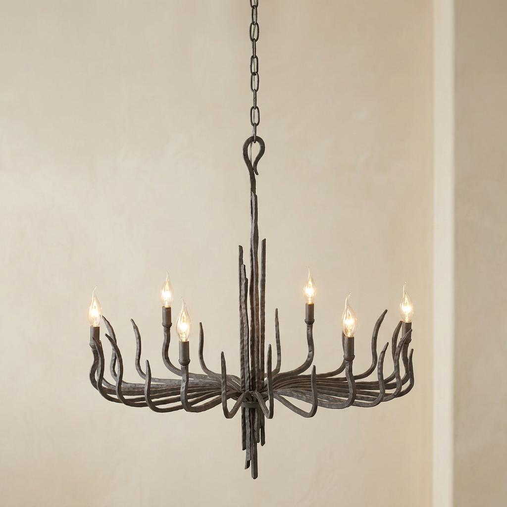 Spyre 6-light bronze modern chandelier with hand-forged branch-like arms and glowing candle-style bulbs.