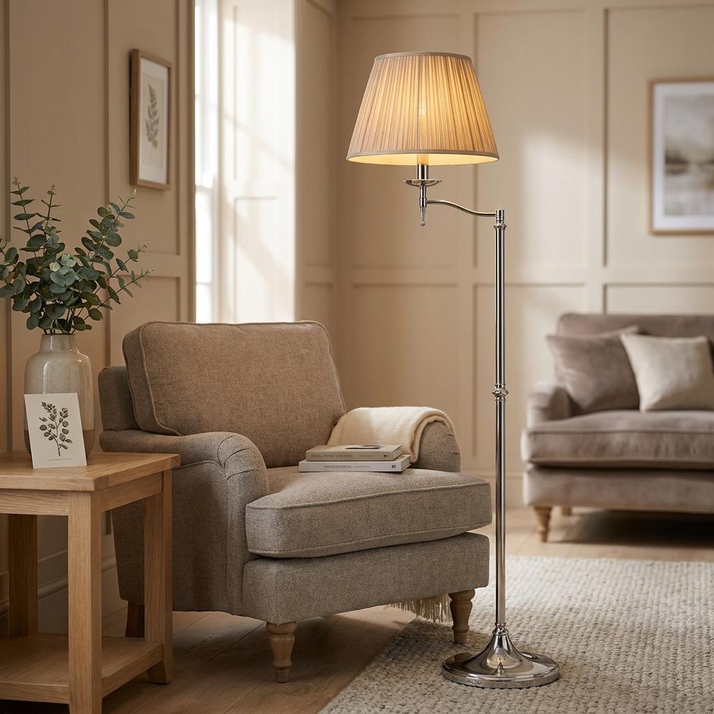 Polished nickel swing arm floor lamp with a pleated shade illuminating a cozy beige living room setting.