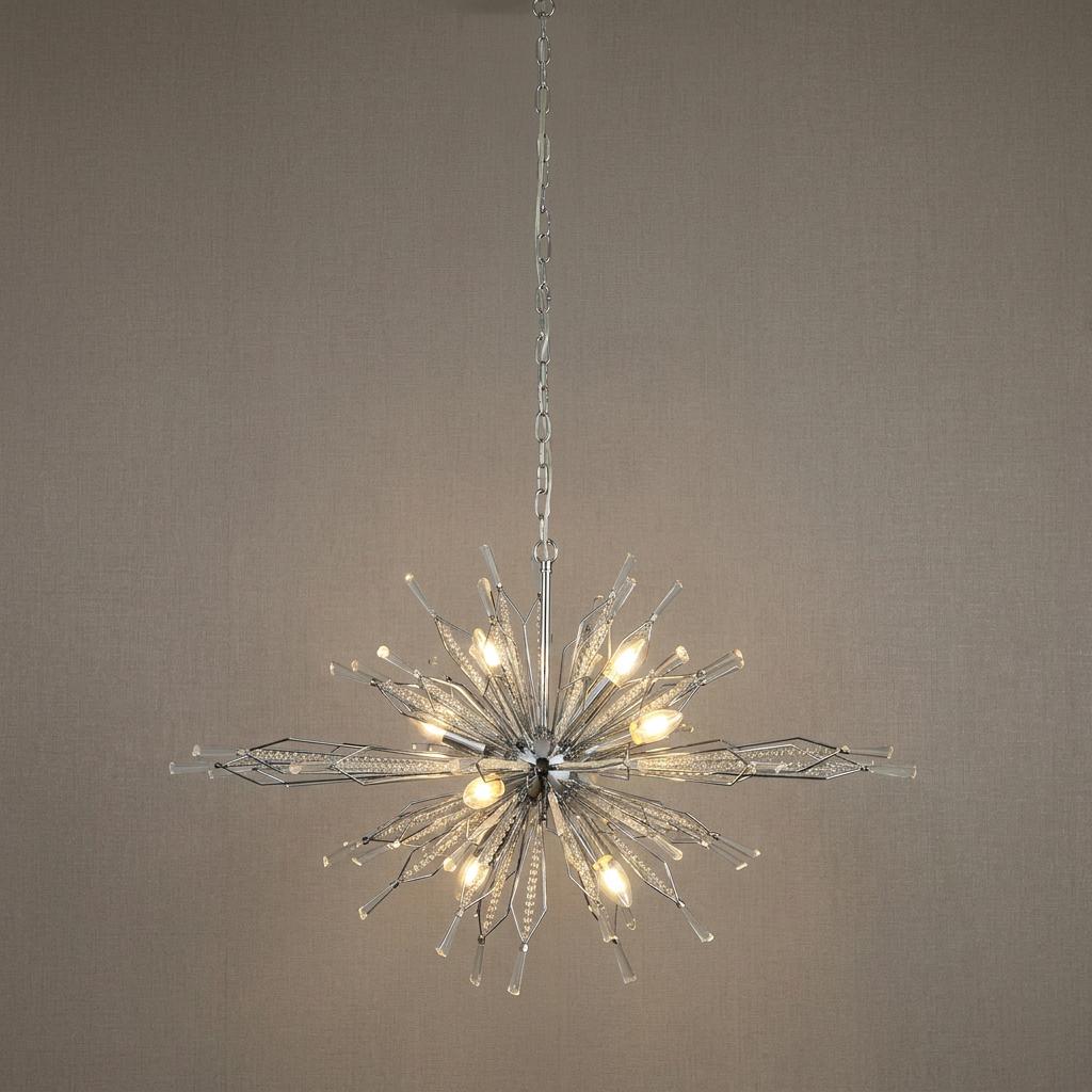 Starburst 8 light chrome and crystal glass ceiling pendant with glowing bulbs against a neutral textured background.