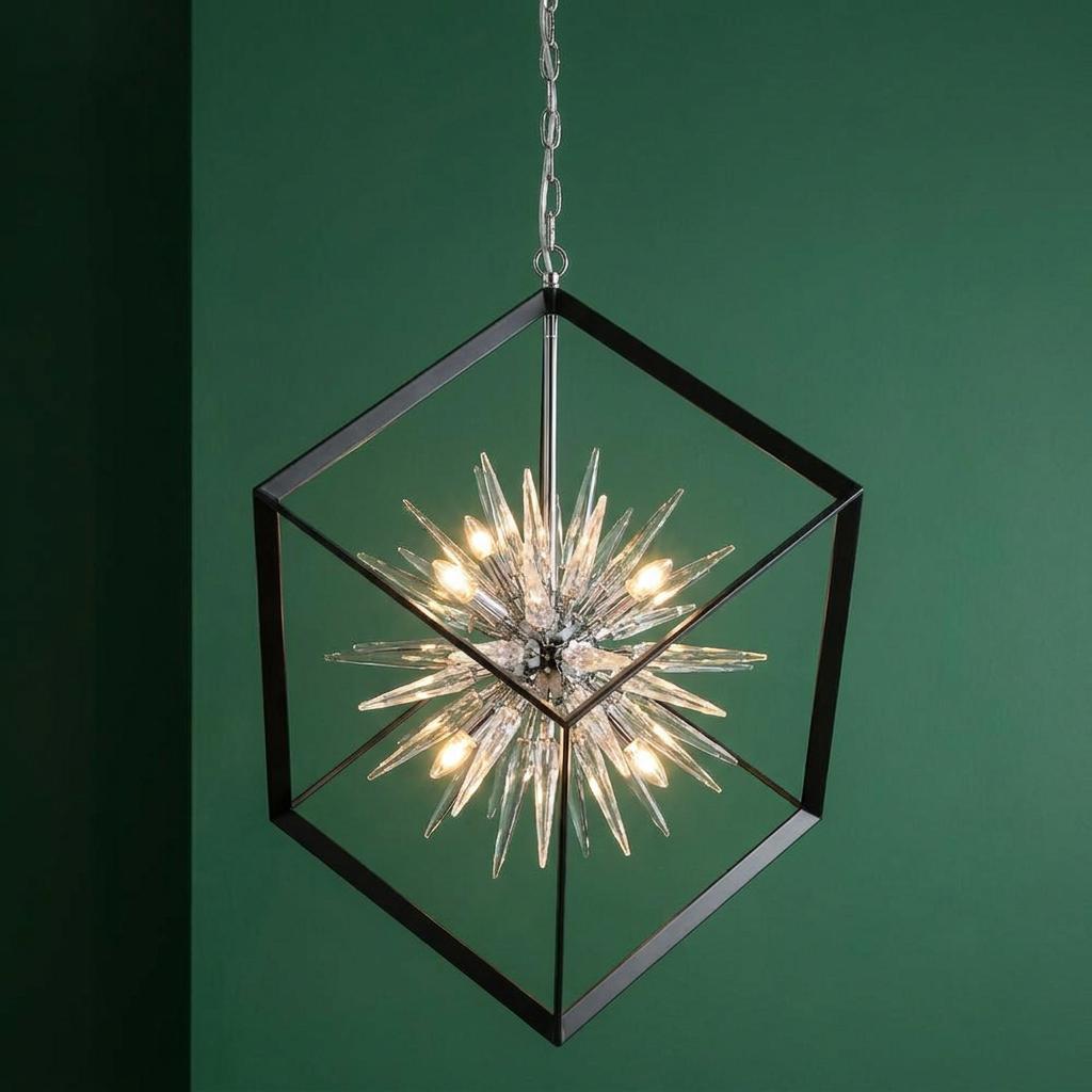 Black hexagonal frame pendant with a crystal starburst center against a green wall.