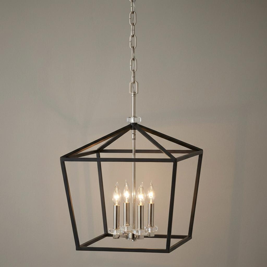 Modern 4-light pendant with a geometric matte black frame and silver candle-style bulbs against a neutral wall.