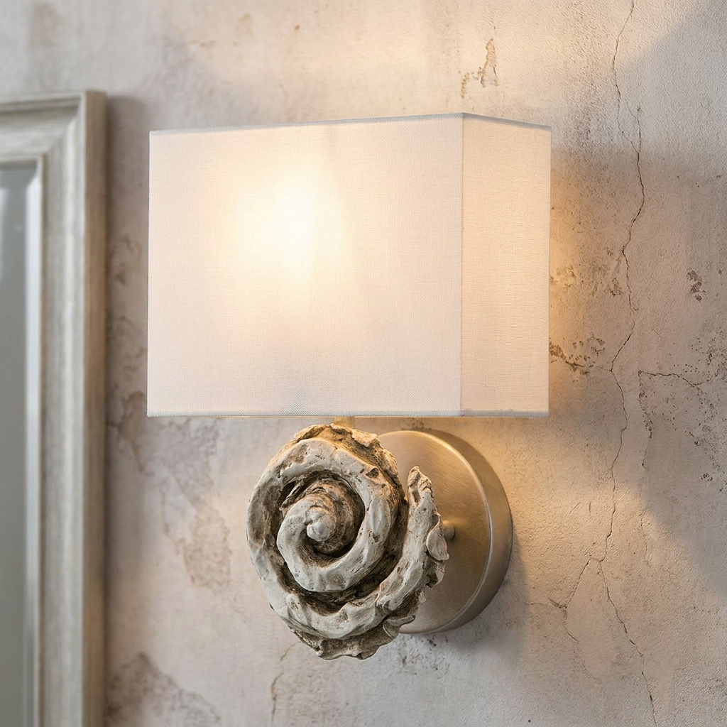Swirl bone white wall light with a shell-inspired base and rectangular fabric shade on a textured wall.