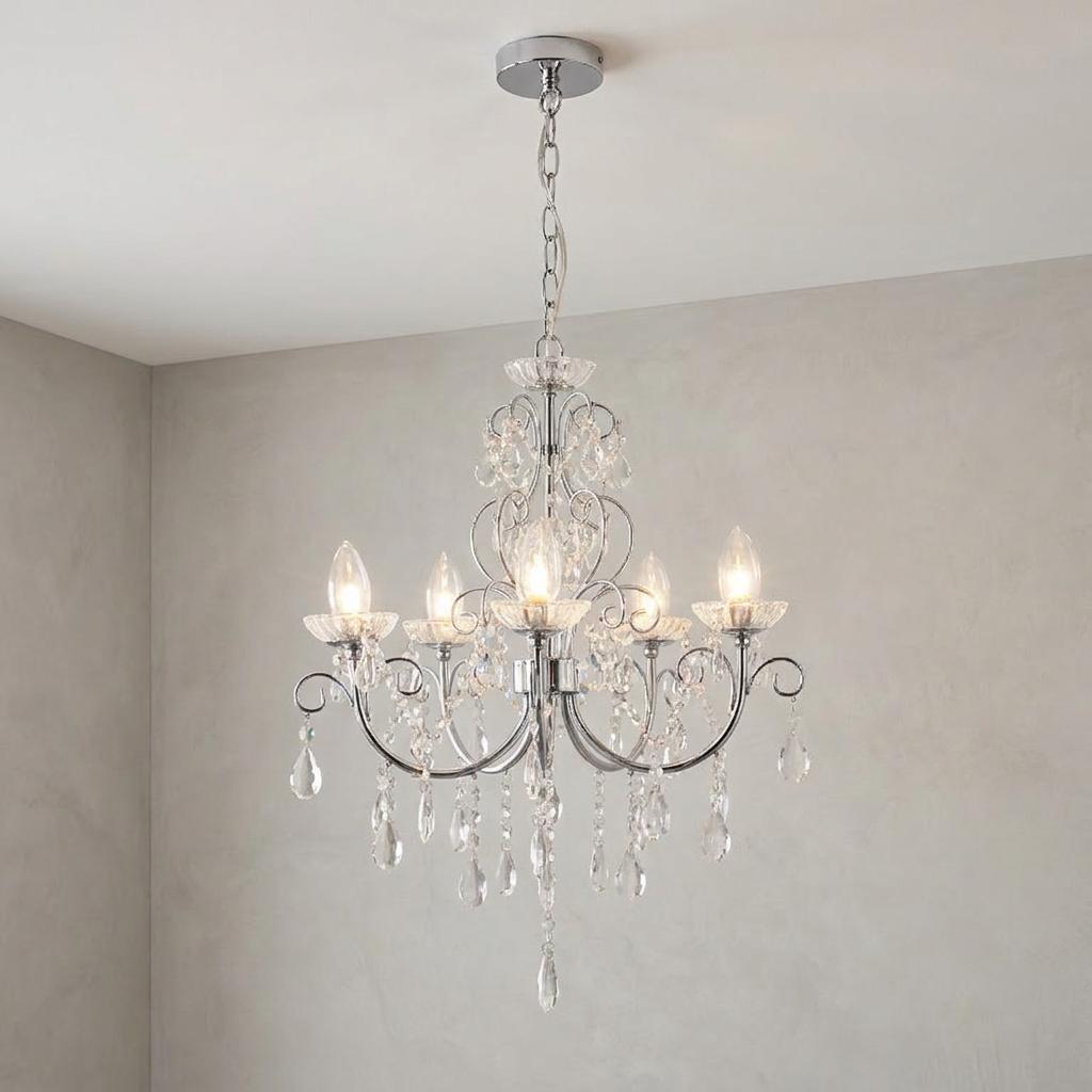 Tabitha crystal glass and chrome five-light chandelier with decorative droplets hanging against a neutral wall.
