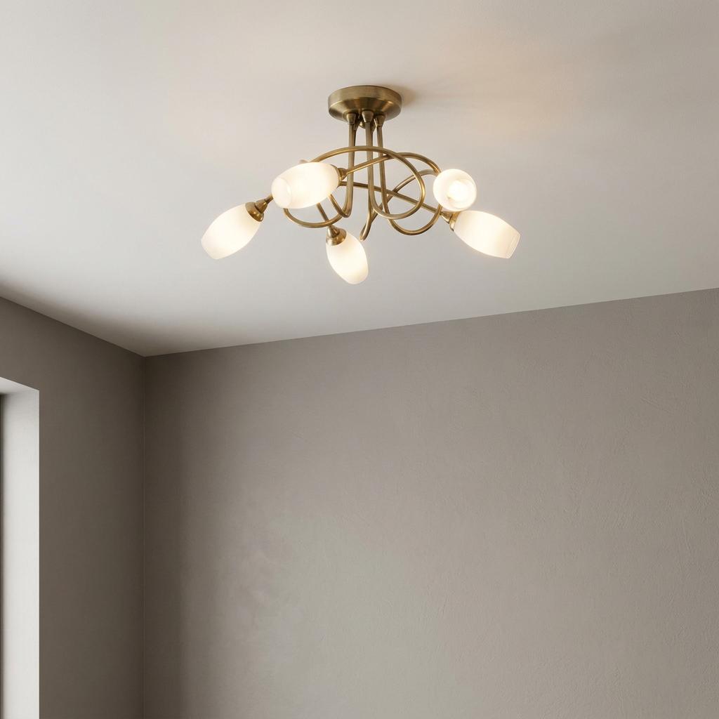 Tara five light antique brass flush ceiling fixture with frosted glass shades and decorative curved arms.