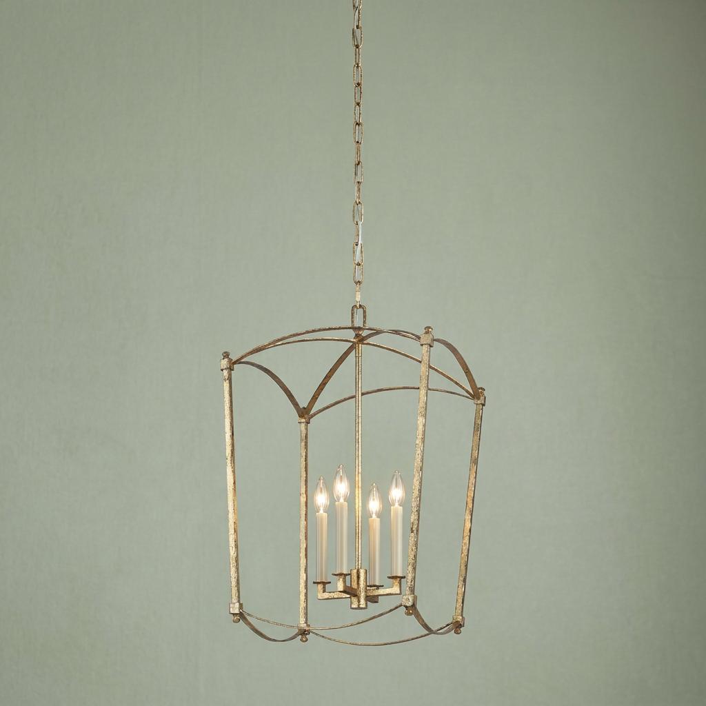 Thayer 4-light gold pendant lantern with candle-style bulbs hanging against a sage green wall.