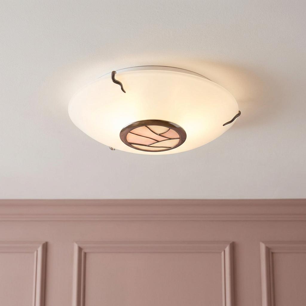 White glass flush ceiling light featuring a central pink and white Tiffany glass detail above a pink paneled wall.