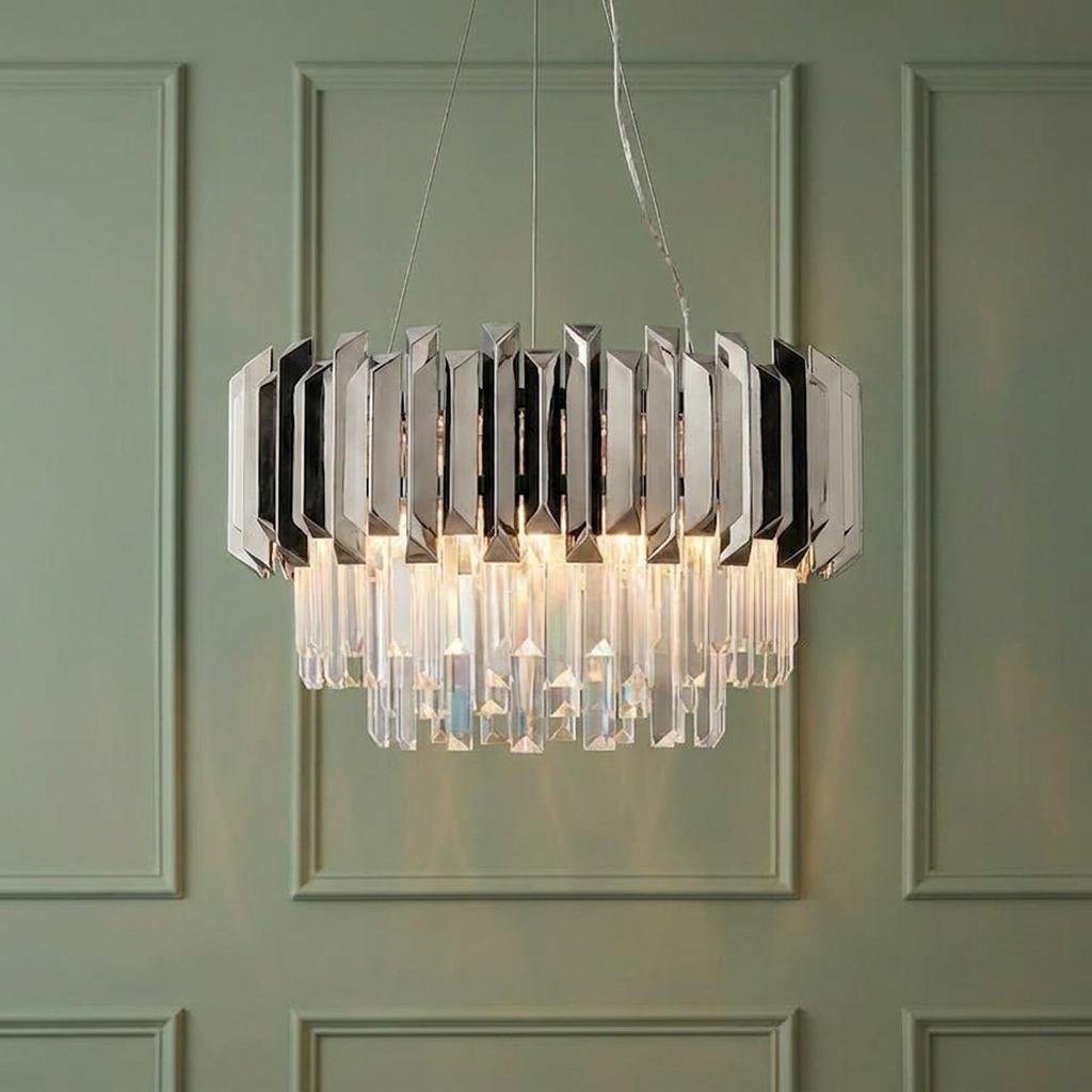 Valetta polished stainless steel and crystal 6 light pendant hanging against a sage green paneled wall.