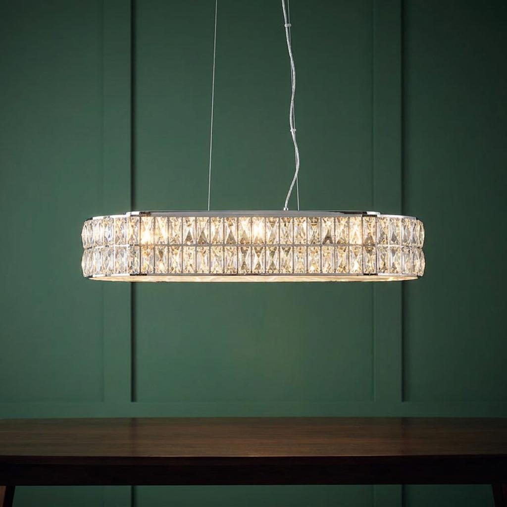 Verina 5 Light Chrome & Crystal Linear Pendant hanging over a wooden table against a dark green paneled wall.