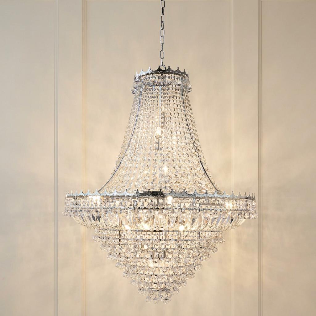 Versailles 19-light chrome and clear crystal chandelier with a tiered, bell-shaped design against a neutral wall.