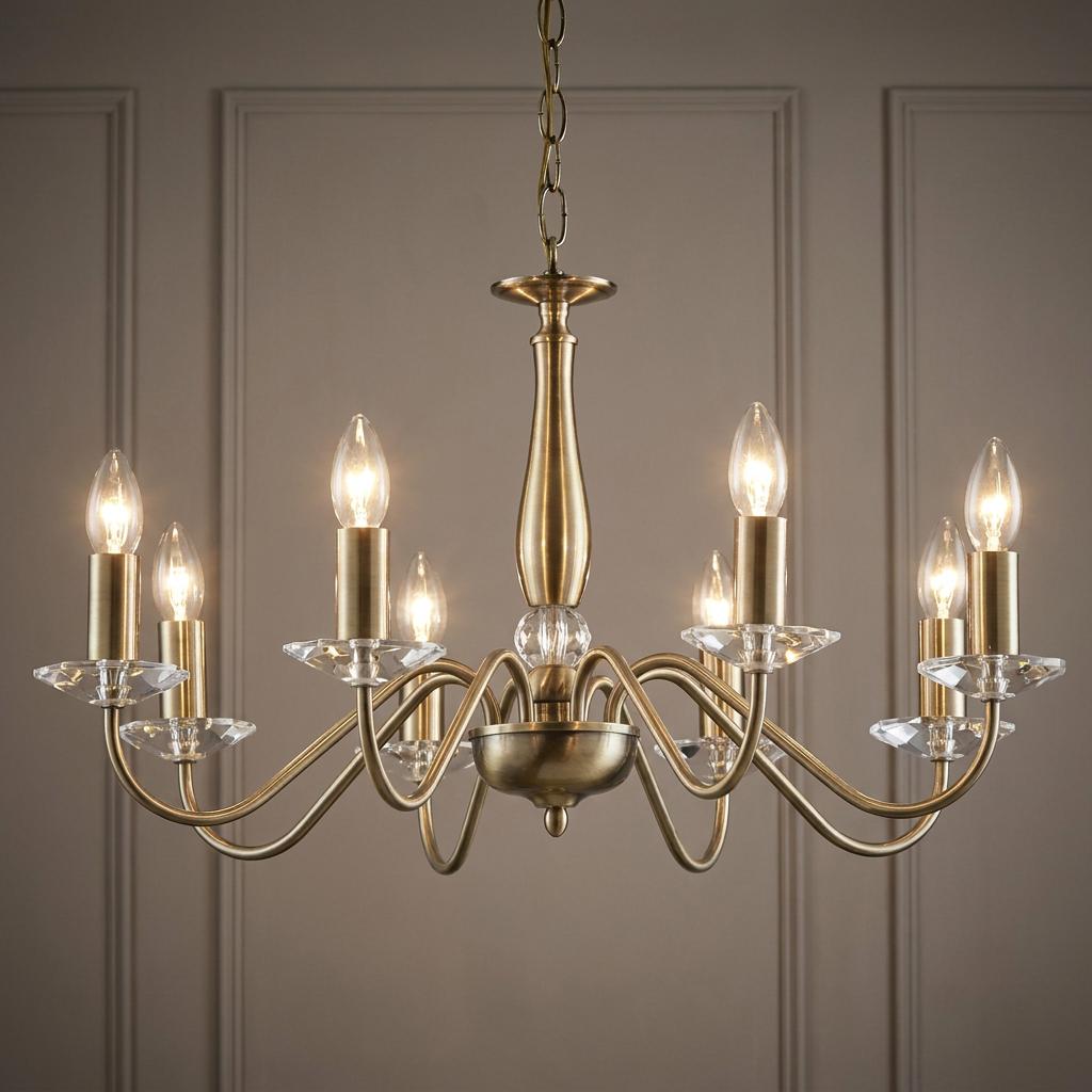 Vesta 8-light antique brass chandelier with curved arms and elegant crystal accents.