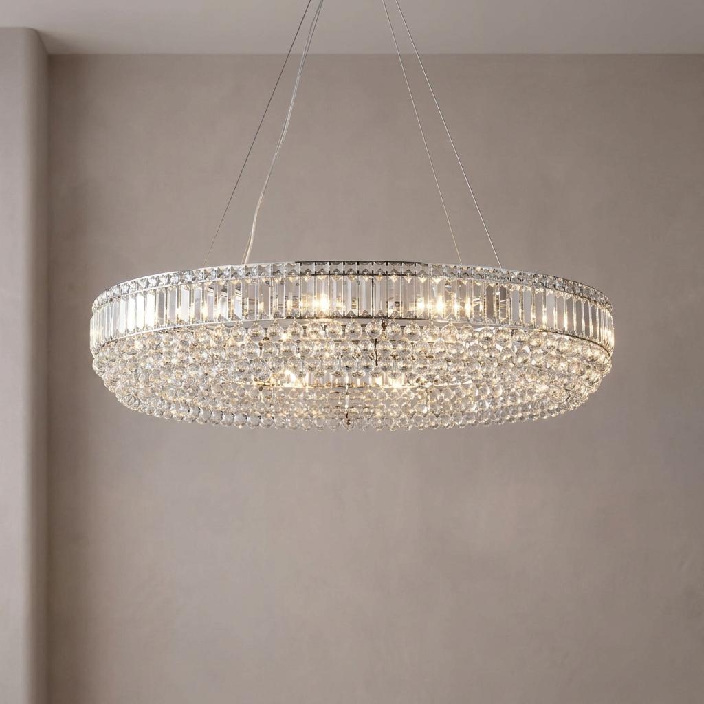 Elegant oval chrome pendant light with shimmering vertical crystal bars and a dense field of clear crystal beads.