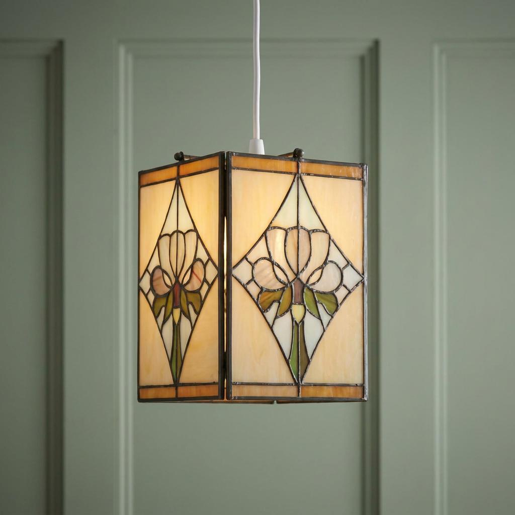 Rectangular Tiffany style pendant light shade with floral stained glass design hanging against a green wall.