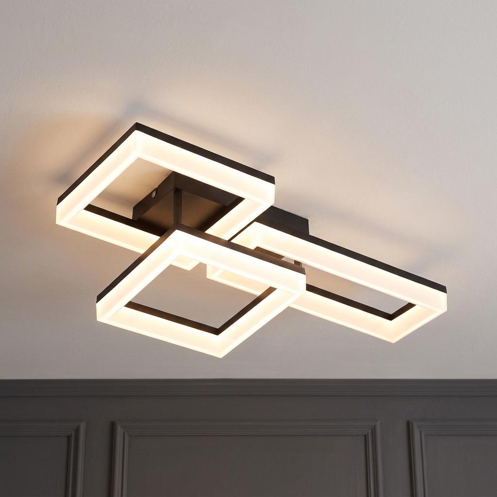 Modern matt black ceiling light with three overlapping, glowing geometric square and rectangular frames.