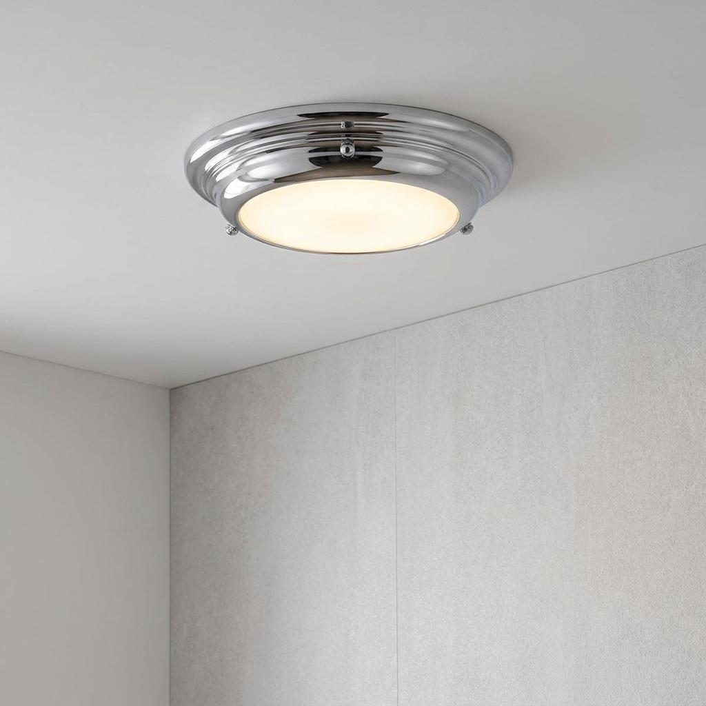Welland Mini LED flush ceiling light with a polished chrome frame and glowing opal diffuser on a white ceiling.